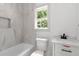 Stylish bathroom with a tiled shower, modern vanity and a window with natural light at 2884 Thompson Cir, Decatur, GA 30034