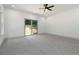 Large bedroom with carpet, a sliding glass door to the backyard, and two bright windows at 2884 Thompson Cir, Decatur, GA 30034