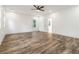 Open bedroom featuring hardwood floors, a ceiling fan, and a connecting bathroom at 2884 Thompson Cir, Decatur, GA 30034