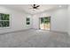 Spacious primary bedroom with bright windows, neutral carpeting, and a sliding glass door to the backyard at 2884 Thompson Cir, Decatur, GA 30034