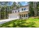 Beautiful two-story white home with a modern design, attached garage, and a spacious lawn at 2884 Thompson Cir, Decatur, GA 30034