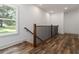 Well-lit hallway with wood floors, modern railings, and view of the outdoors at 2884 Thompson Cir, Decatur, GA 30034
