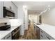 Well-lit kitchen featuring stainless steel appliances, gray cabinets, quartz countertops, and modern lighting at 2884 Thompson Cir, Decatur, GA 30034