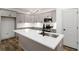 Contemporary kitchen featuring sleek gray cabinets, stainless steel appliances, and a central island with a sink at 2884 Thompson Cir, Decatur, GA 30034