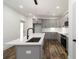 Contemporary kitchen with gray cabinets, quartz countertops, a stainless steel range and microwave, and wood flooring at 2884 Thompson Cir, Decatur, GA 30034