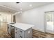 Modern kitchen island with quartz countertop, stylish lighting, and stainless steel dishwasher, with an adjacent patio door at 2884 Thompson Cir, Decatur, GA 30034