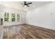 Sunlit living room featuring wood floors, a ceiling fan, a fireplace and a glass door leading to the yard at 2884 Thompson Cir, Decatur, GA 30034
