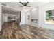 Bright living room features wood floors, fireplace, ceiling fan, staircase and open kitchen in a modern design at 2884 Thompson Cir, Decatur, GA 30034