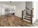 Open concept living area with hardwood floors, a modern light fixture, and staircase at 2884 Thompson Cir, Decatur, GA 30034
