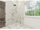 Bright bathroom with modern shower, large format tile and backyard view at 2884 Thompson Cir, Decatur, GA 30034