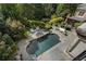 Aerial view of a backyard featuring a pool, spa, lush landscaping, and outdoor seating areas at 3560 Ridgewood Nw Rd, Atlanta, GA 30327