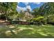 Expansive backyard with lush greenery and view of the stately home at 3560 Ridgewood Nw Rd, Atlanta, GA 30327