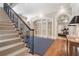 Elegant foyer featuring a staircase with iron railings and arched doorways leading to other rooms at 3560 Ridgewood Nw Rd, Atlanta, GA 30327
