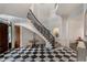 Elegant foyer with a winding staircase and checkered marble flooring at 3560 Ridgewood Nw Rd, Atlanta, GA 30327