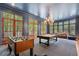 Spacious game room with a pool table, foosball table, and ample natural light from large windows at 3560 Ridgewood Nw Rd, Atlanta, GA 30327
