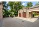 Three-car garage with a basketball hoop and a spacious driveway at 3560 Ridgewood Nw Rd, Atlanta, GA 30327