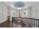 Elegant hallway featuring a curved staircase, chandelier, and round windows at 3560 Ridgewood Nw Rd, Atlanta, GA 30327