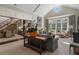 Open living room with fireplace, bay window, and view of dining area and staircase at 3560 Ridgewood Nw Rd, Atlanta, GA 30327