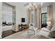Elegant living room with paneled walls, coffered ceiling, and access to the main bedroom at 3560 Ridgewood Nw Rd, Atlanta, GA 30327
