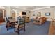 Open-concept living and dining area with fireplace, comfortable seating, and natural light at 3560 Ridgewood Nw Rd, Atlanta, GA 30327