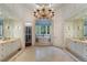 Luxurious main bathroom with dual vanities, chandelier, and soaking tub at 3560 Ridgewood Nw Rd, Atlanta, GA 30327