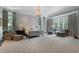 Spacious main bedroom features sitting area, chandelier, and large windows at 3560 Ridgewood Nw Rd, Atlanta, GA 30327