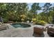 Stunning outdoor pool area surrounded by lush landscaping and stone patio at 3560 Ridgewood Nw Rd, Atlanta, GA 30327