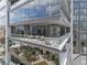 Modern condo balcony with glass railings offers cityscape views and comfortable seating for outdoor relaxation at 3107 Peachtree Ne Rd # 1101, Atlanta, GA 30305