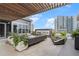 Stylish covered patio featuring modern outdoor seating, a fireplace, and lush greenery, ideal for relaxation at 3107 Peachtree Ne Rd # 1101, Atlanta, GA 30305