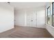 A carpeted bedroom featuring a double door closet and a window at 3859 Allegretto Cir # 121, Atlanta, GA 30339