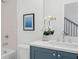 Bathroom featuring a stylish vanity, tiled walls, and a bathtub with shower, complete with an elegant orchid at 3324 Springhaven Ave, Atlanta, GA 30354