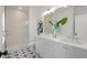 Bathroom with a glass-enclosed shower, dual sinks, modern fixtures, and stylish star-patterned floor tiles at 3324 Springhaven Ave, Atlanta, GA 30354