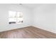Bright, empty bedroom featuring a large window that floods the room with natural light and light hardwood floors at 3324 Springhaven Ave, Atlanta, GA 30354