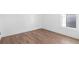 An empty bedroom with light hardwood floors and a window offering a view of the outdoors at 3324 Springhaven Ave, Atlanta, GA 30354