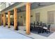 Inviting covered patio with wooden columns, ceiling fans, and dining area for outdoor entertaining at 3324 Springhaven Ave, Atlanta, GA 30354