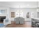 Open concept dining area with modern chandelier and connection to the living space at 3324 Springhaven Ave, Atlanta, GA 30354