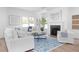 Bright living room featuring a fireplace, and elegant decor with hardwood floors and natural light at 3324 Springhaven Ave, Atlanta, GA 30354