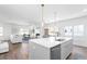 Open kitchen flows to a spacious living room, with modern lighting and a fireplace at 3324 Springhaven Ave, Atlanta, GA 30354