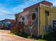 Exterior wall adorned with a large, artistic mural showcasing a portrait and seascape at 3324 Springhaven Ave, Atlanta, GA 30354