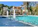 Community swimming pool with water features, lounge chairs, and black metal fencing at 3324 Springhaven Ave, Atlanta, GA 30354