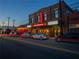 Exterior of the Academy Theatre featuring a red lit-up sign and a street scene with cars at 3324 Springhaven Ave, Atlanta, GA 30354