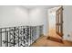 Hallway with ornate railings and an open doorway, revealing hardwood floors at 1261 Lavista Rd # F-3, Atlanta, GA 30324