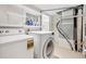 Well-lit laundry area features washer, dryer, shelving, and utilities for efficient home maintenance at 1261 Lavista Rd # F-3, Atlanta, GA 30324