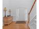 Bright entryway with hardwood floors, staircase, and decorative console table at 175 S Links S Dr, Covington, GA 30014