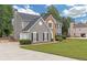 Two-story house with gray siding, stone accents, and a two-car garage at 175 S Links S Dr, Covington, GA 30014