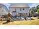 Large backyard with a patio cover, playset, and plenty of grassy space at 2535 Grayton Loop, Villa Rica, GA 30180