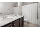 Clean bathroom with double sinks, dark brown vanity, and a shower/tub combo at 2535 Grayton Loop, Villa Rica, GA 30180