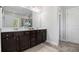 Elegant bathroom with double sinks, dark brown vanity, and a large mirror at 2535 Grayton Loop, Villa Rica, GA 30180