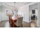 Dining room with hardwood floors, chandelier, and farmhouse table at 2535 Grayton Loop, Villa Rica, GA 30180