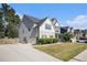 Two-story house with gray siding, stone accents, and a landscaped lawn at 2535 Grayton Loop, Villa Rica, GA 30180